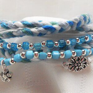 Handmade bracelet with rows of threads, beads, and charms No. 240